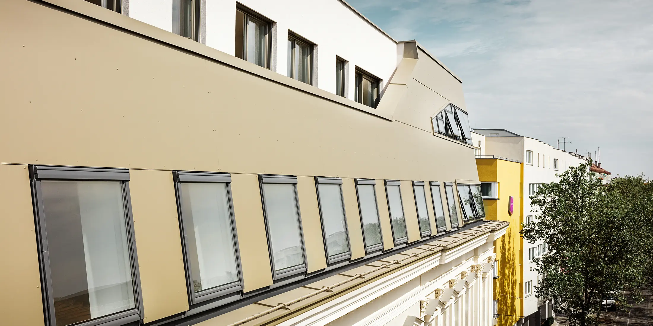 Takflateutbygging i Schloßhofer Straße i Wien med aluminiumskomposittplate i bronse fra PREFA