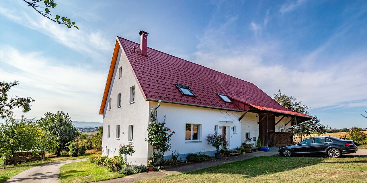 Gammel liten bondegård, vakkert renovert med PREFA takplate i oksydrød.